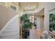 Elegant curved staircase with a tiled floor and plant accents at 6401 S Jamaica Cir, Englewood, CO 80111