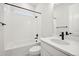 Clean bathroom with white subway tiles, bathtub, and modern vanity at 5959 S Platte Canyon Dr, Littleton, CO 80123
