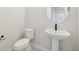 Small bathroom with pedestal sink and toilet at 5959 S Platte Canyon Dr, Littleton, CO 80123
