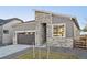 Modern home with stone and siding accents, a two-car garage, and a landscaped front yard at 5959 S Platte Canyon Dr, Littleton, CO 80123