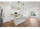 Modern kitchen with island, stainless steel appliances, and white cabinets at 5959 S Platte Canyon Dr, Littleton, CO 80123