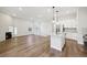 Open concept kitchen with island, stainless steel appliances, and white cabinets at 5959 S Platte Canyon Dr, Littleton, CO 80123