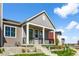 Gray farmhouse-style home with a front porch and landscaped yard at 5663 W 142 Ave, Broomfield, CO 80020