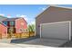 Exterior view of a house with a red exterior and attached garage at 5663 W 142 Ave, Broomfield, CO 80020