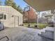 Spacious backyard with stamped concrete patio, basketball hoop, and detached garage at 1056 S Harrison St, Denver, CO 80209