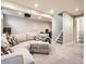 Finished basement with sectional sofa, projector, and stairs to upper levels at 1056 S Harrison St, Denver, CO 80209