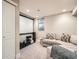 Finished basement with sectional sofa and projector screen at 1056 S Harrison St, Denver, CO 80209