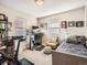 Bright bedroom featuring a Peloton bike and home office at 1056 S Harrison St, Denver, CO 80209