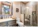Elegant bathroom with a glass shower, stone tile, and updated vanity at 456 Crystal Ridge Rd, Evergreen, CO 80439