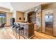 Rustic bar with stone backsplash and seating at 456 Crystal Ridge Rd, Evergreen, CO 80439
