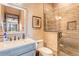 Modern bathroom with a glass shower, stone tile, and updated vanity at 456 Crystal Ridge Rd, Evergreen, CO 80439