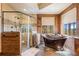 Luxurious bathroom with a copper soaking tub and walk-in shower at 456 Crystal Ridge Rd, Evergreen, CO 80439
