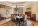 Elegant dining room features a large table, chandelier, and hardwood floors at 456 Crystal Ridge Rd, Evergreen, CO 80439