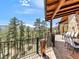 Large deck with mountain views and outdoor seating at 456 Crystal Ridge Rd, Evergreen, CO 80439