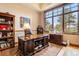 Spacious home office with built-in shelves, large windows, and mountain views at 456 Crystal Ridge Rd, Evergreen, CO 80439
