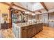 Open kitchen with a sizable island, wood cabinets, and granite countertops at 456 Crystal Ridge Rd, Evergreen, CO 80439