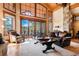 Spacious living room with large windows, hardwood floors, and mountain views at 456 Crystal Ridge Rd, Evergreen, CO 80439