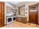 Convenient laundry room with built-in cabinets and a sink at 456 Crystal Ridge Rd, Evergreen, CO 80439