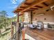 Large covered patio with mountain views, outdoor kitchen, and dining area at 456 Crystal Ridge Rd, Evergreen, CO 80439