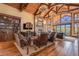 Spacious living room with vaulted ceilings, stone fireplace, and mountain views at 456 Crystal Ridge Rd, Evergreen, CO 80439