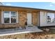 Front entry of brick ranch home with steps and landscaping at 19536 E Iowa Cir, Aurora, CO 80017