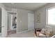 bedroom with neutral walls, carpeted floors, and access to another room at 45012 Sunflower Ln, Bennett, CO 80102