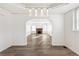 Bright dining room with hardwood floors and view into living room with fireplace at 1517 W Nevada Pl, Denver, CO 80223