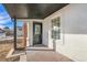 Inviting front porch with a black door and updated flooring at 1517 W Nevada Pl, Denver, CO 80223