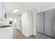 Modern kitchen with white cabinets, stainless steel appliances and quartz countertops at 1517 W Nevada Pl, Denver, CO 80223