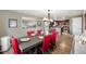 Open concept dining room with red chairs and a view into the updated kitchen at 6589 W Louisiana Pl, Lakewood, CO 80232