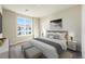 Bright bedroom with a queen-size bed, gray bedding, and ample natural light at 6153 N Ceylon St # 305, Denver, CO 80249
