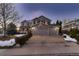 Two-story home with a three-car garage and landscaping at 3761 Black Feather Trl, Castle Rock, CO 80104