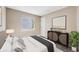 Neutral bedroom with a comfortable bed and mid-century modern dresser at 5256 S Ukraine St, Aurora, CO 80015