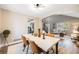 Dining room with light walls, hardwood floors, and a view to the living room at 5256 S Ukraine St, Aurora, CO 80015