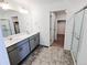 Elegant bathroom with double vanity, walk-in shower, and separate toilet area at 2412 Valley Sky St, Fort Lupton, CO 80621