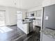 Modern kitchen with gray cabinets and granite countertops at 2412 Valley Sky St, Fort Lupton, CO 80621