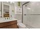 Modern bathroom with walk-in shower and white cabinetry at 540 Scrubjay Trl, Castle Rock, CO 80104