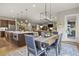 Bright dining area with spacious table, adjacent to kitchen and living room at 540 Scrubjay Trl, Castle Rock, CO 80104