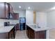 Modern kitchen with dark brown cabinets and stainless steel appliances at 1221 Bistre St, Longmont, CO 80501