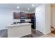 Modern kitchen with dark brown cabinets and island, stainless steel appliances at 1221 Bistre St, Longmont, CO 80501