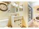 Bathroom with white vanity, shower/tub combo, and laundry area at 309 E Highline Cir # 101, Centennial, CO 80122