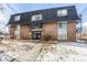 Brick building exterior with walkway and landscaping; winter scene at 309 E Highline Cir # 101, Centennial, CO 80122