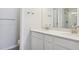 Modern bathroom with double vanity, white cabinets, and a separate toilet at 455 Interlocken Blvd # 102, Broomfield, CO 80021