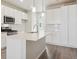 Modern kitchen with white cabinets, quartz countertop, stainless steel appliances, and an island at 455 Interlocken Blvd # 102, Broomfield, CO 80021