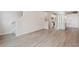 Open living room with wood-look flooring, view of the kitchen, and staircase at 455 Interlocken Blvd # 102, Broomfield, CO 80021