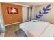 Bedroom with a king-size bed, wall-mounted TV, and an accent wall at 2200 W Moffat Pl, Denver, CO 80221
