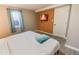Bedroom with a king-size bed, wall-mounted TV, and an accent wall at 2200 W Moffat Pl, Denver, CO 80221