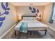 Spacious bedroom with a king-size bed, unique wall art, and plenty of natural light at 2200 W Moffat Pl, Denver, CO 80221