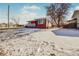 Brick ranch home with a covered porch and snowy lawn at 2200 W Moffat Pl, Denver, CO 80221