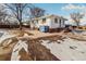 Side view of a ranch home with a concrete patio at 2200 W Moffat Pl, Denver, CO 80221